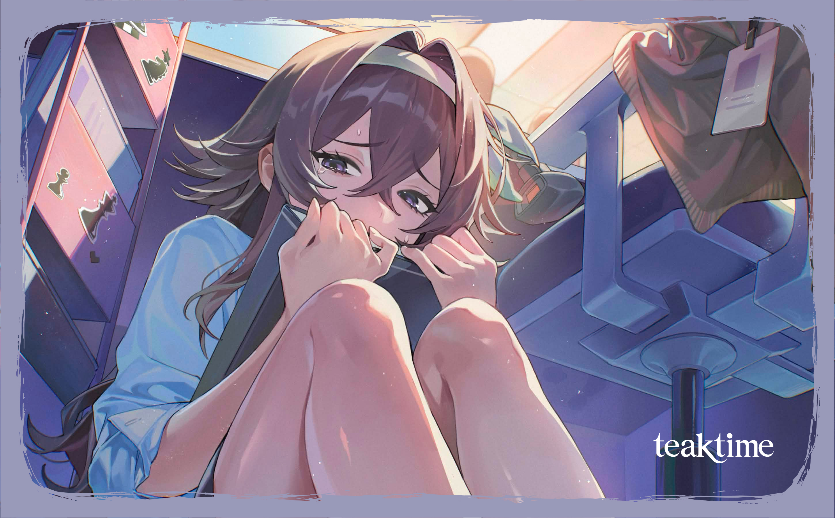 Faye sitting beneath a table, looking at her phone.